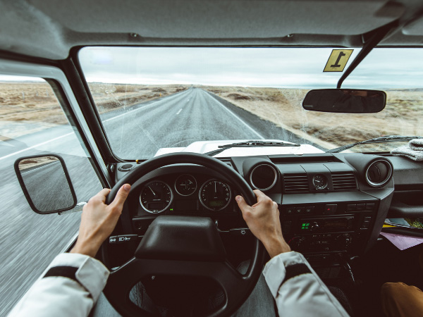 A men is driving Jeep on a free road