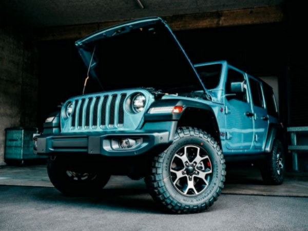 Blue and White Jeep Wrangler in a garage