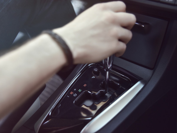 hand holding automatic transmission in jeep JK