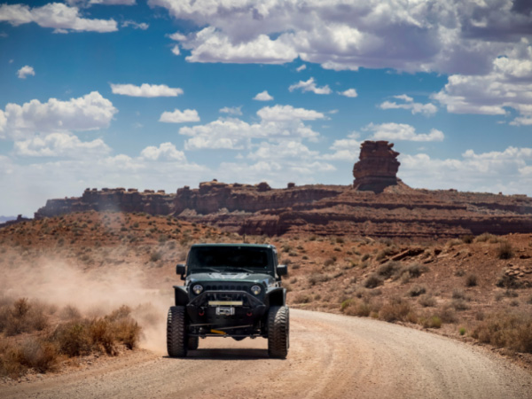 landscape view of 4WD car on desert road