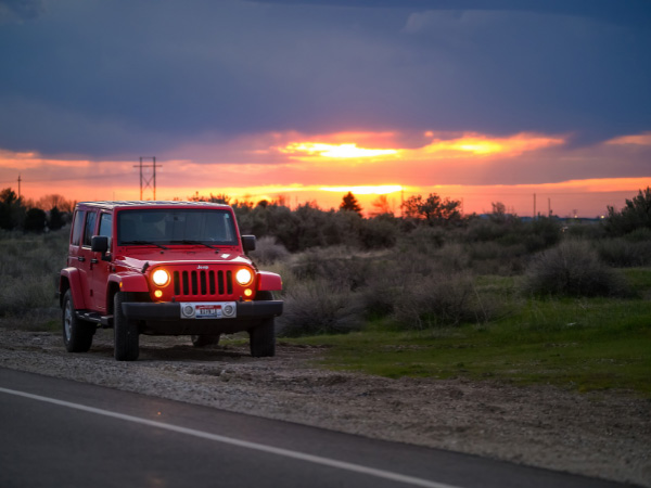 red jeep cherokee beside road