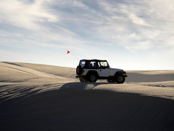 sand dune with jeep and spare tire