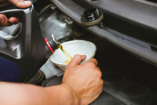 Mechanic Pouring Synthetic Oil to Vehicle Engine