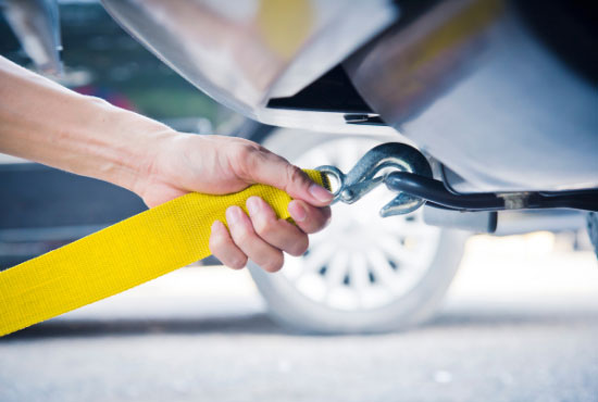 hands towing car with towing rope